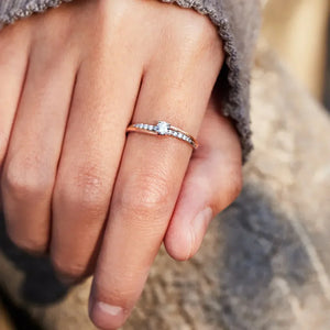 Dual band silver ring with diamond accents and a central stone.
