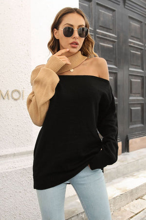 Black and camel asymmetric shoulder-baring knit sweater with cut-out neckline.