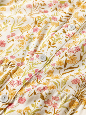 Floral print button-down shirt dress with pink and yellow flowers on a white background.