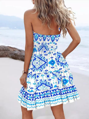 Tribal print halter mini dress with tiered ruffle skirt and side slit.