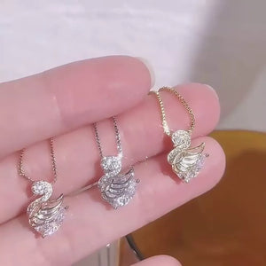Swan pendant necklaces in gold, silver, and rose gold, featuring cubic zirconia and 925 sterling silver.