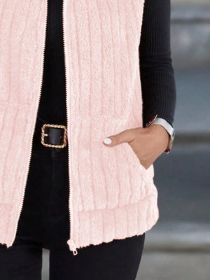 Pink fleece zip-up vest with pockets and ribbed texture.