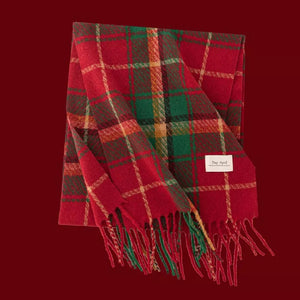 Cozy plaid scarf in red, green, and cream with fringe details.