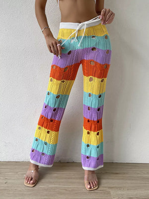 Vibrant crochet knit maternity pants with rainbow stripes and cutout details.