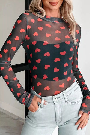 Black sheer mesh top with red heart print, long sleeves, and mock neck.