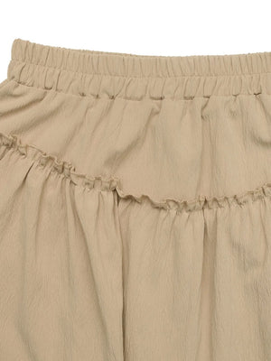 Tiered ruffle mini skirt in tan with elastic waistband and textured fabric.