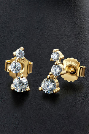 Gold moissanite cluster stud earrings with three round-cut stones each.