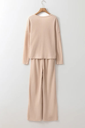 Tan textured ribbed loungewear set with long sleeve top and wide leg pants.