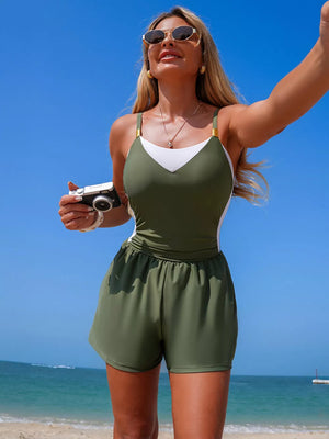 Chic color block maternity one-piece swimsuit in army green and white with adjustable straps and shorts.