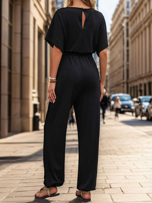 Black jumpsuit with short sleeves, keyhole back detail, and wide legs.