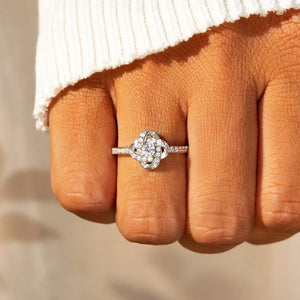 Silver intertwined crystal knot ring with pavé band.