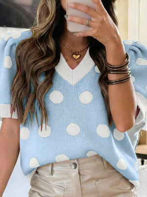 Light blue polka dot knit sweater with puff sleeves and a white v-neck trim.