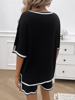Black knit lounge set with white contrast trim on neckline, sleeves, and shorts.