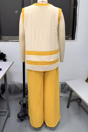 Yellow polyester flowy pants and cream sleeveless top with yellow stripes.