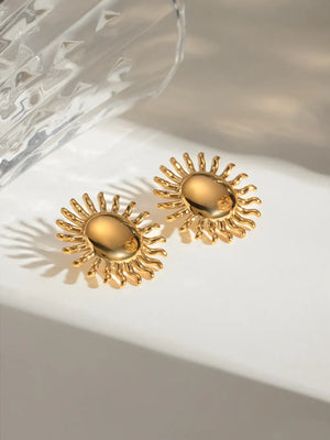 Gold sun stud earrings with sculptural rays, 18K gold-plated.