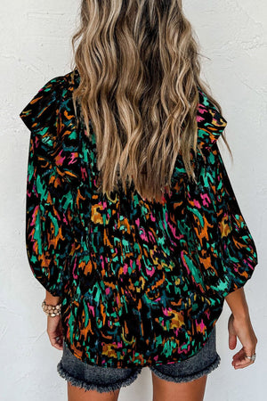 Black abstract print blouse with ruffled aura sleeves and puff sleeves.