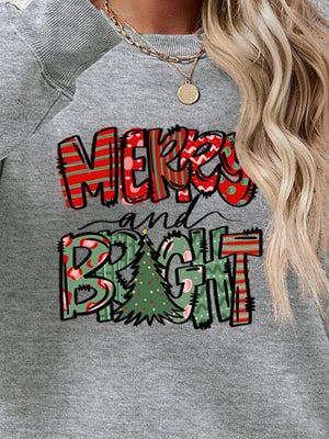 Crewneck sweatshirt with Merry and Bright Christmas graphic in red and green patterns.