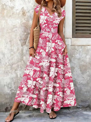 Elegant tiered maxi dress in Strawberry floral print with smocked bodice and V-neck.