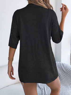Black openwork knit duster cardigan with elbow-length sleeves and diamond pattern detail.