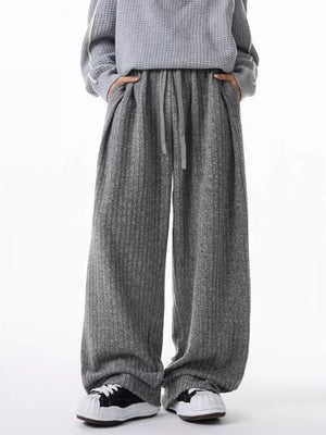 Relaxed fit ribbed knit sweatpants in dark gray with a drawstring waist and pockets.