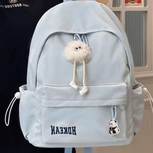 Light blue nylon backpack with fluffy charm and panda keychain