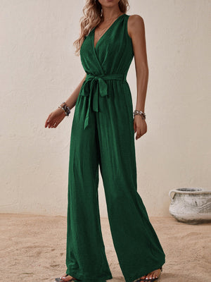 Dark green textured wrap-front wide-leg jumpsuit with tie waist and V-neck.