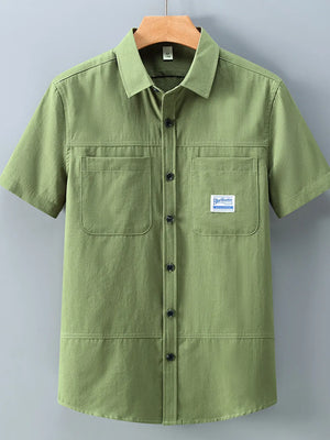 Men's moss green cotton short-sleeve utility shirt with two chest pockets and button front.