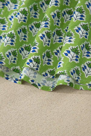 Floral tie-strap tank top with square neckline in green cotton with blue and white floral print.