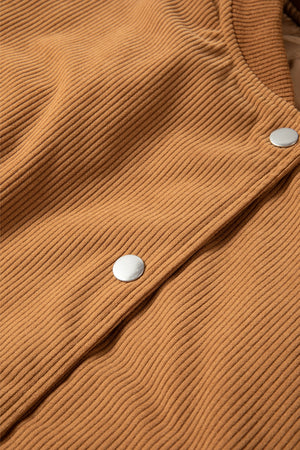 Terracotta corduroy bomber jacket detail with silver snap buttons.