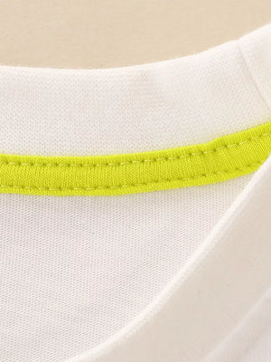 White cotton toddler t-shirt with bright lime green neckline trim.