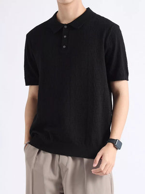 Black cotton blend short-sleeve polo with button detail and classic collar.
