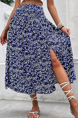 Ditsy floral midi skirt with a high slit and smocked waist, styled with white gladiator sandals.
