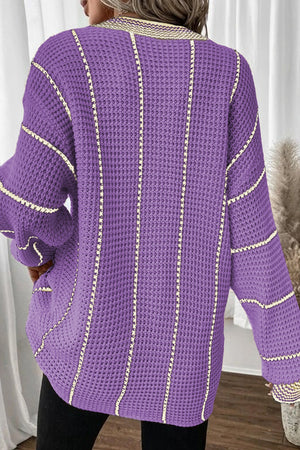 Lavender knit oversized V-neck dress with vertical stripe detail and waffle texture.