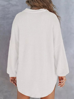 White waffle-knit henley tee with buttoned collar and long sleeves.
