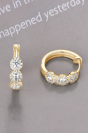 Gold triple cluster diamond huggie hoop earrings with sparkling cubic zirconia.