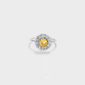 Silver sunflower ring with yellow gemstone center and detailed petals.