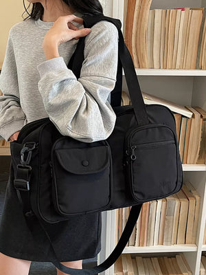 Black nylon duffle bag with multiple exterior pockets and adjustable strap.