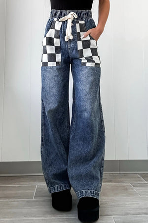 Checkerboard pocket wide-leg jeans in medium acid wash denim with drawstring waist.