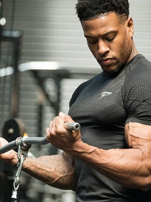 Black performance fit raglan sleeve tee with textured pattern and short sleeves.