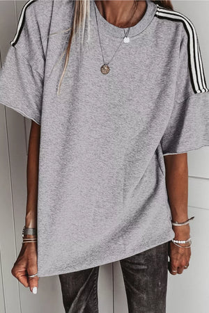 Grey relaxed t-shirt with black and white shoulder stripes and raw hem sleeves.