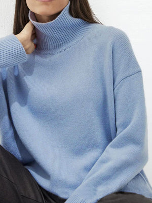 Light blue acrylic turtleneck sweater with sculptural sleeves.