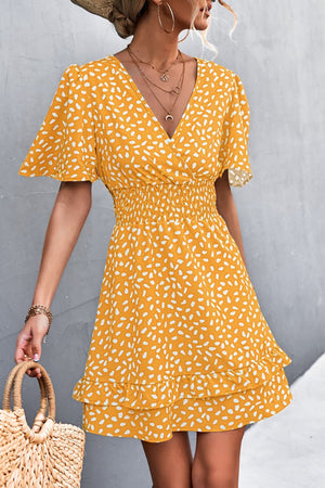 Mustard smocked waist mini dress with flutter sleeves and white speckle print.