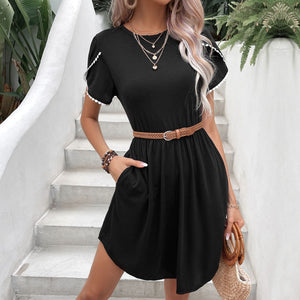 Black casual day dress with scalloped sleeves and a braided belt.