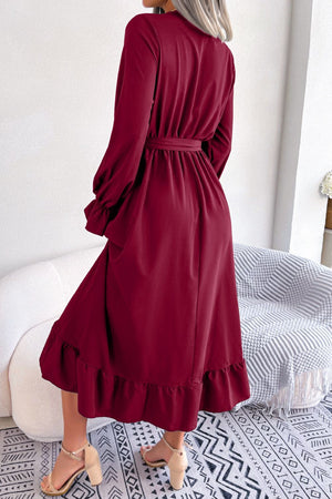 Wine midi dress with long sleeves, tie waist, ruffled hem, and lace trim detail.