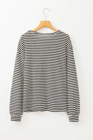 Black and white striped long sleeve tee with a crew neck.