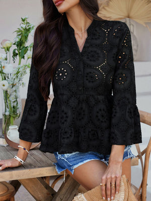 Black eyelet embroidered peplum blouse with ruffles and bell sleeves.