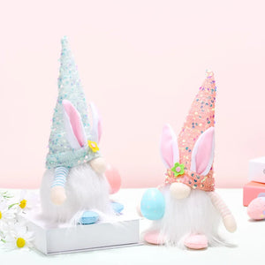 Easter bunny gnomes with sequin cone hats in light blue and coral, holding eggs.