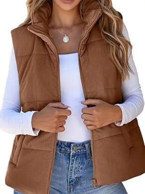 Dark brown ribbed corduroy zip-up vest coat with quilted detail and stand collar.