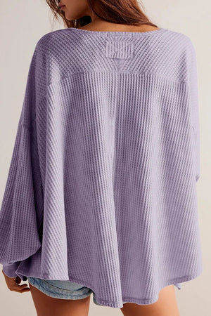 Lavender waffle knit blouse with blouson sleeves and a relaxed fit.