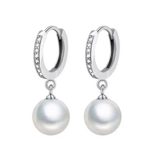 Elegant pearl drop hoop earrings with cubic zirconia accents.